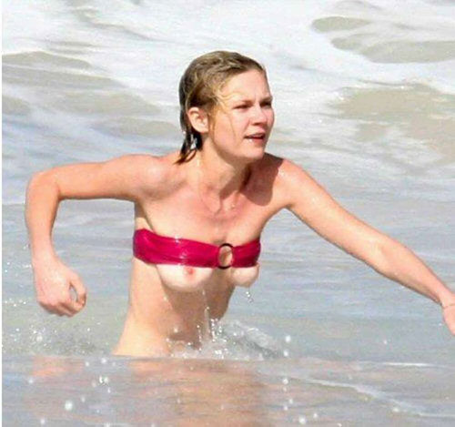 Kirsten Dunst's tits pop out of her bikini.